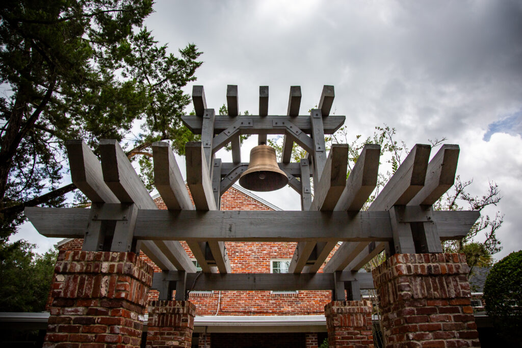 Large bronze ASEC Bell hung from wood and brick pergola