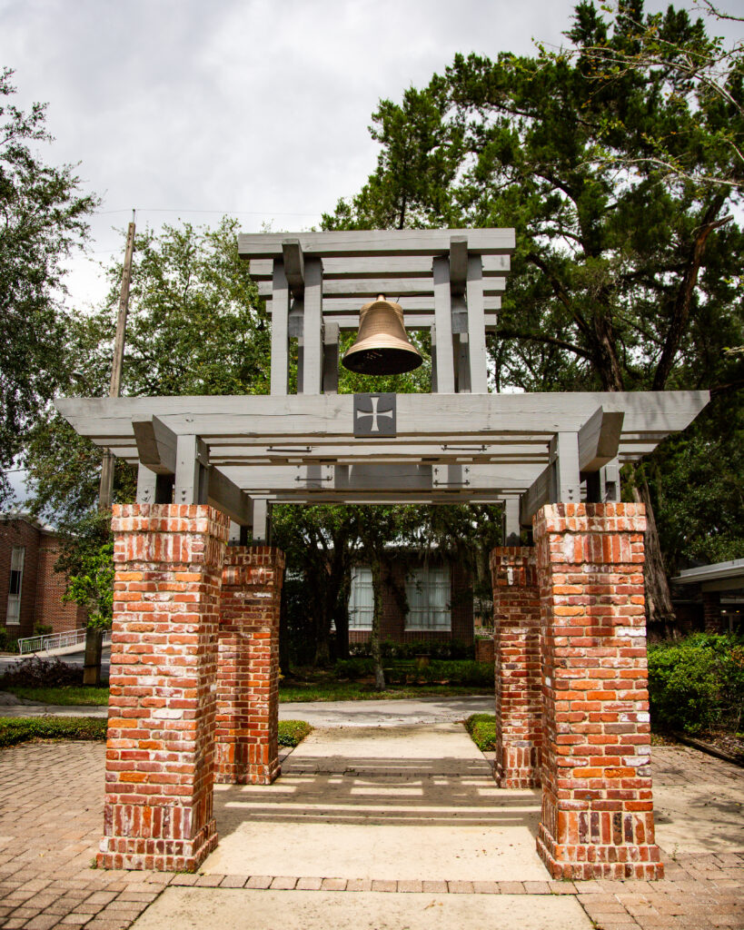 Large bronze ASEC Bell hung from wood and brick pergola
