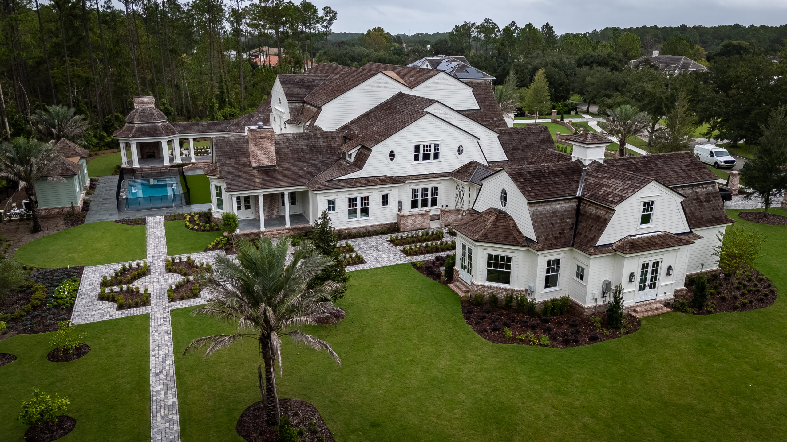 aerial view of large white house and property