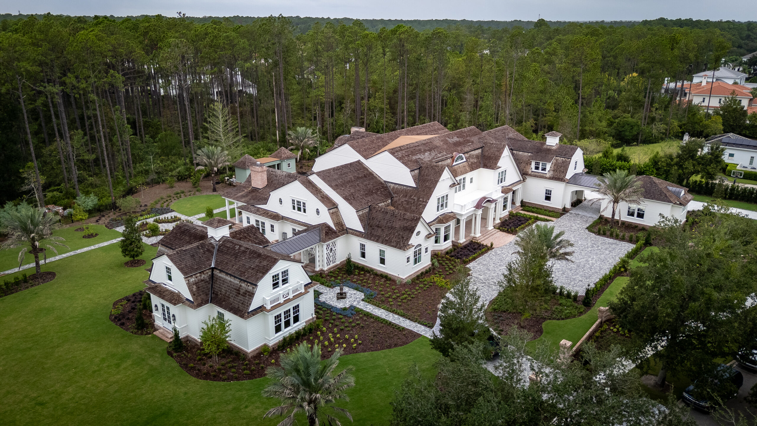 aerial view of large white house and property