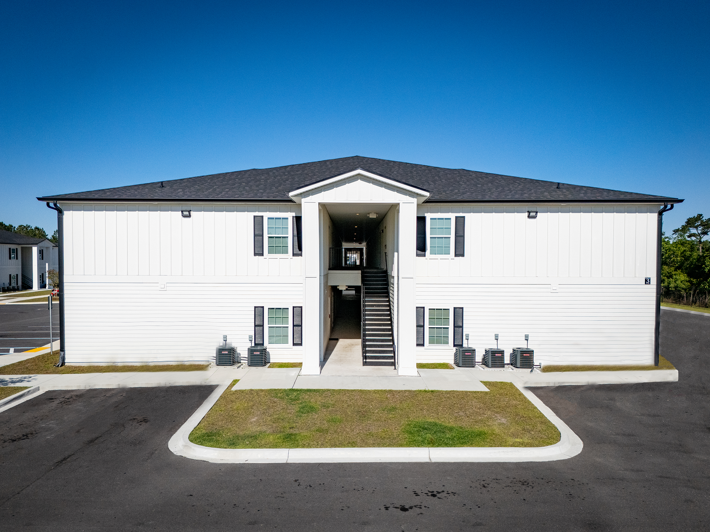 front view of a white two story apartment building