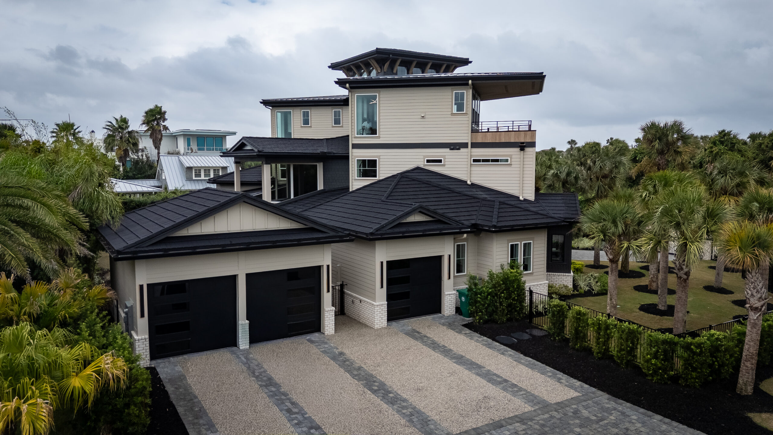 back of a large house with three garage doors